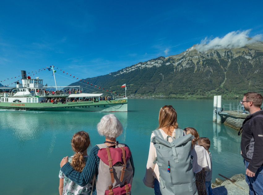 Familie schaut auf anfahrendes DS Lötschberg auf dem Brienzersee